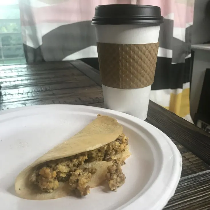 Easy Keto Crepes with Sausage Egg and Cheese Recipe 3 Keto Crepe filled with sausage egg and cheese sitting on a table with coffee
