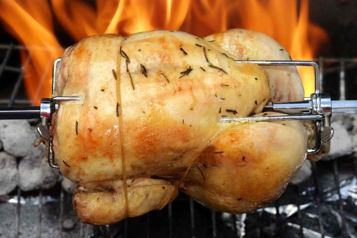 Keto Chicken Soup Recipe with Just 3 Net Carbs Rotisserie chicken cooking over an open flame, seasoned and ready to be used as a flavorful ingredient in keto chicken soup