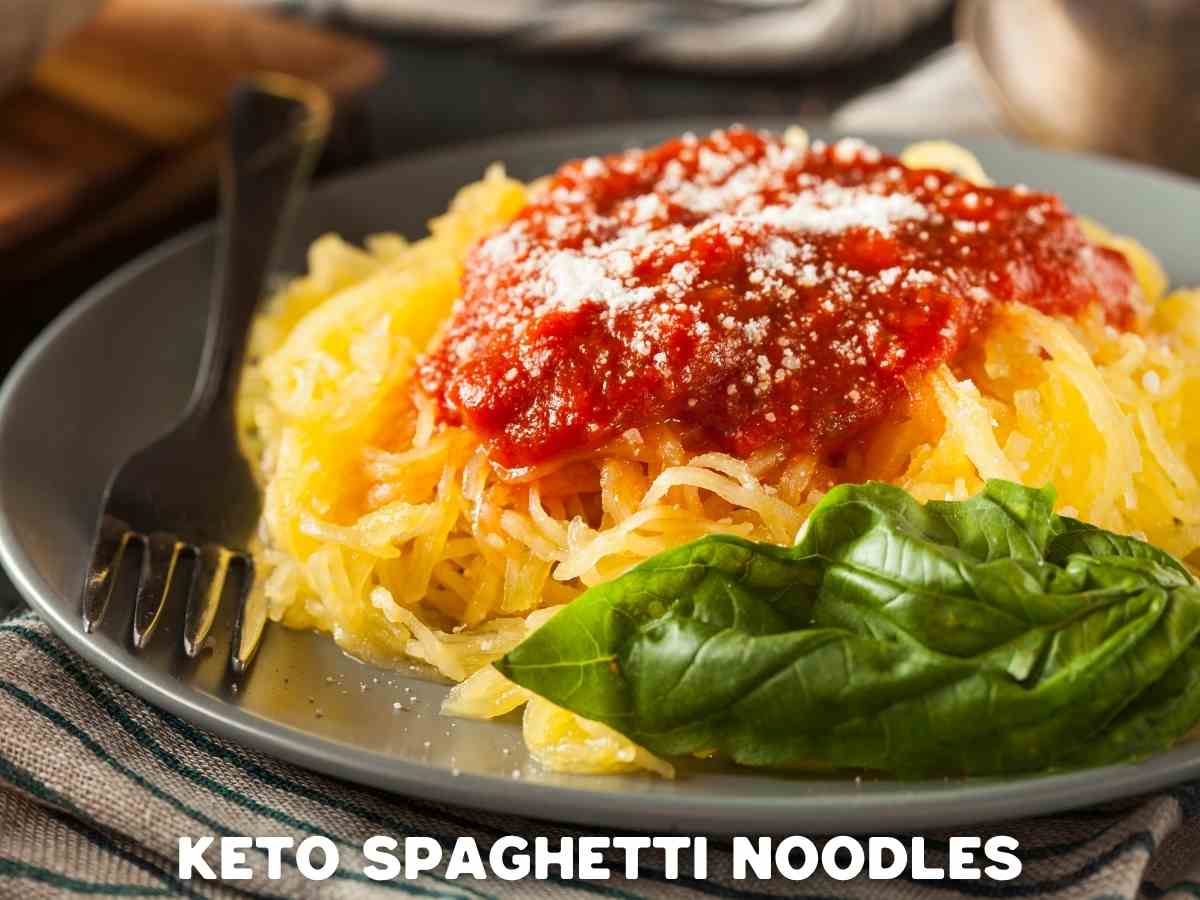 10 Delicious Keto Noodles To Swap Your Carby Pasta For a plate filled with keto spaghetti noodles topped with basil and a low carb marinara sauce