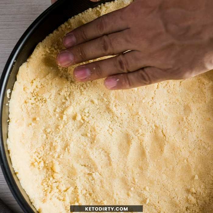 press instant pot keto cheesecake crust into cheesecake pan