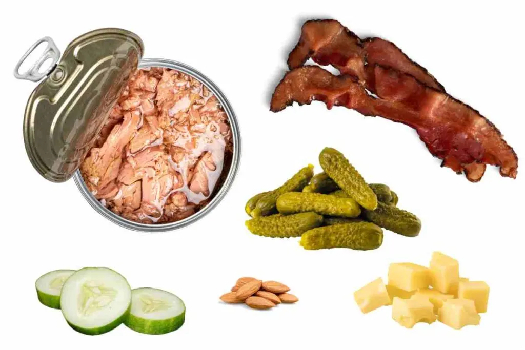 best carb free snacks photo featuring a sample of the zero carb snack ideas including tuna fish, cucumbers, pickles, cheese, bacon and almonds